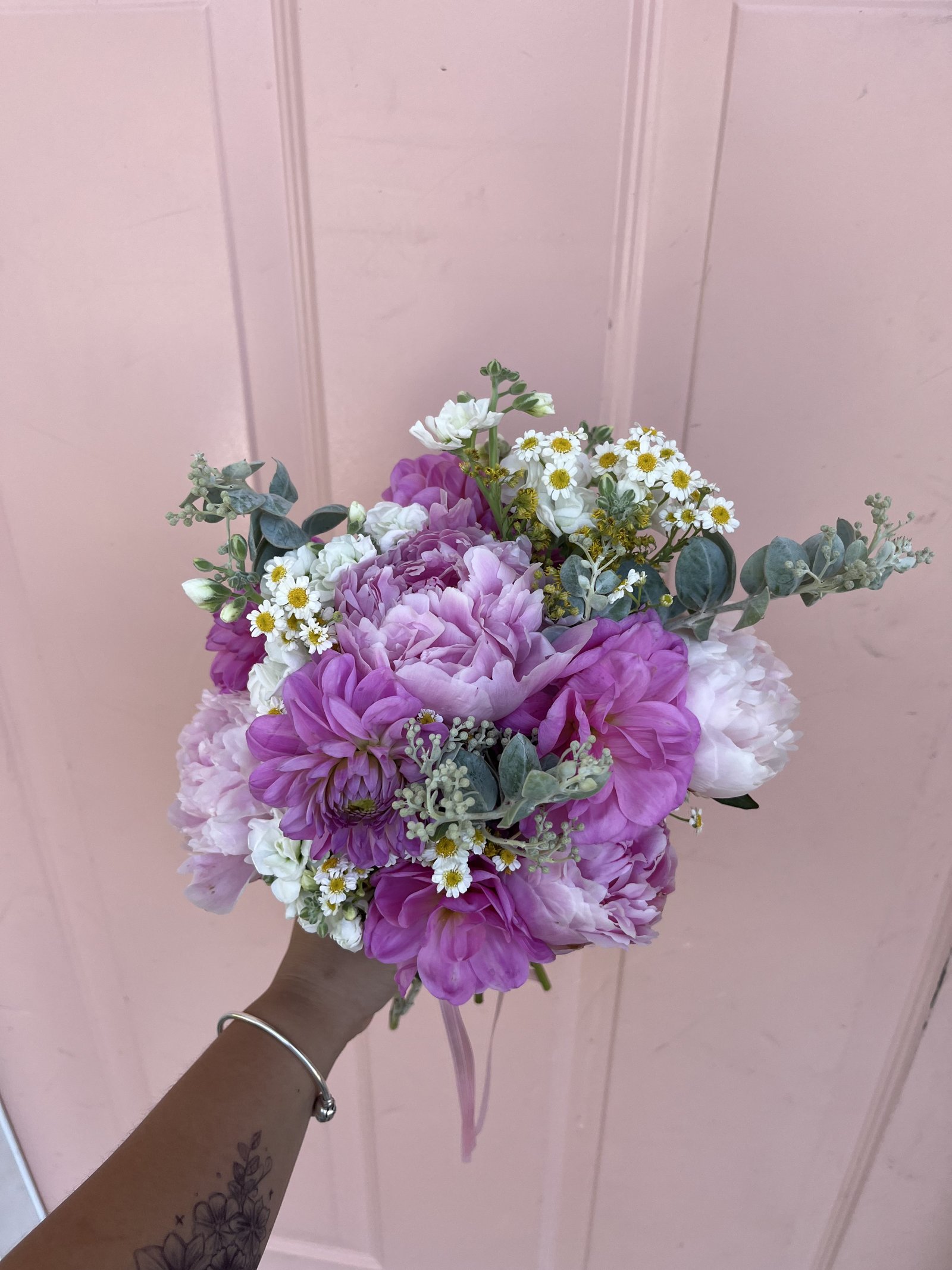 Lush pink peony and dahlia bridal bouquet with eucalyptus