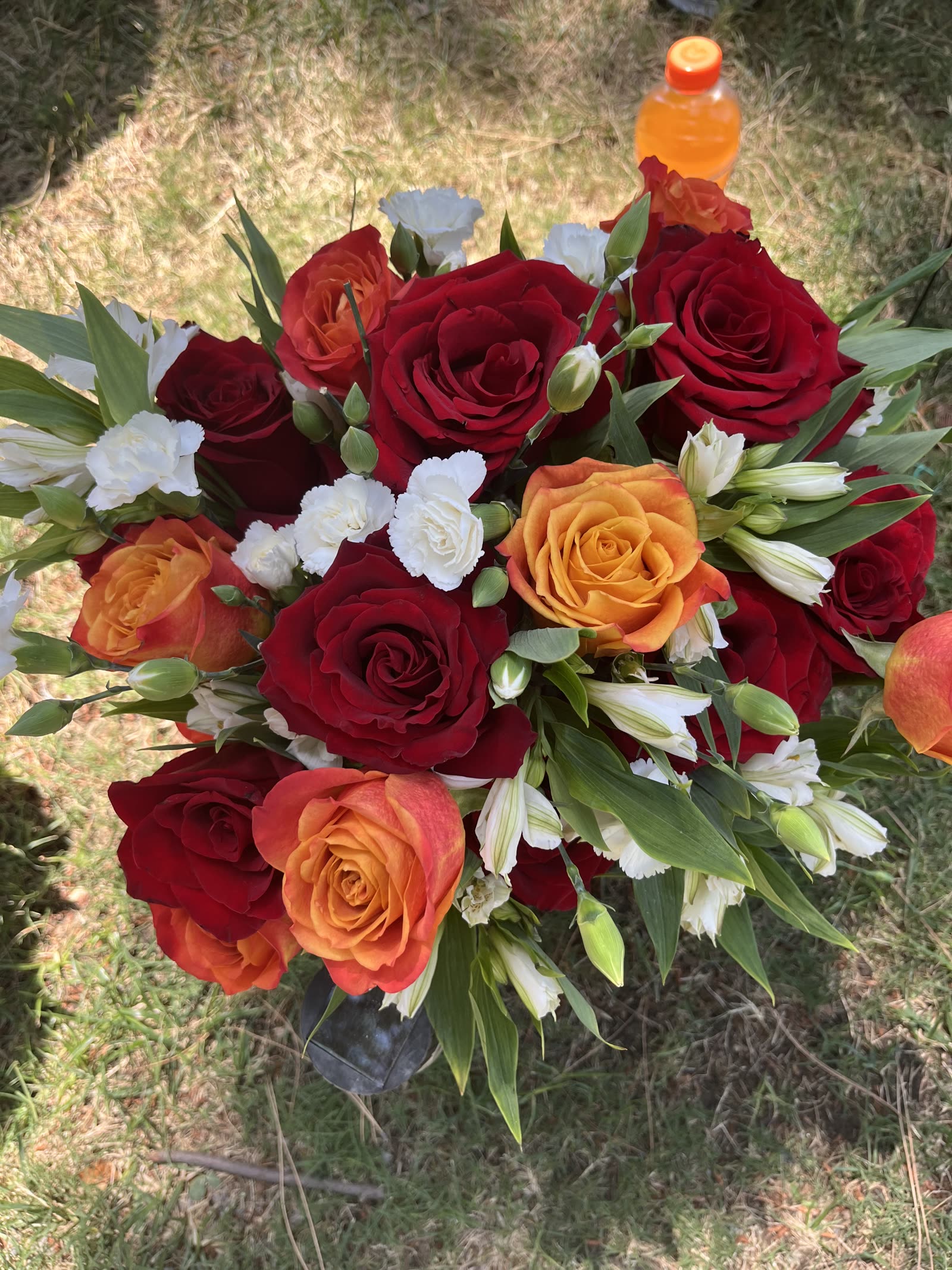 Red and orange rose arrangement with white carnations