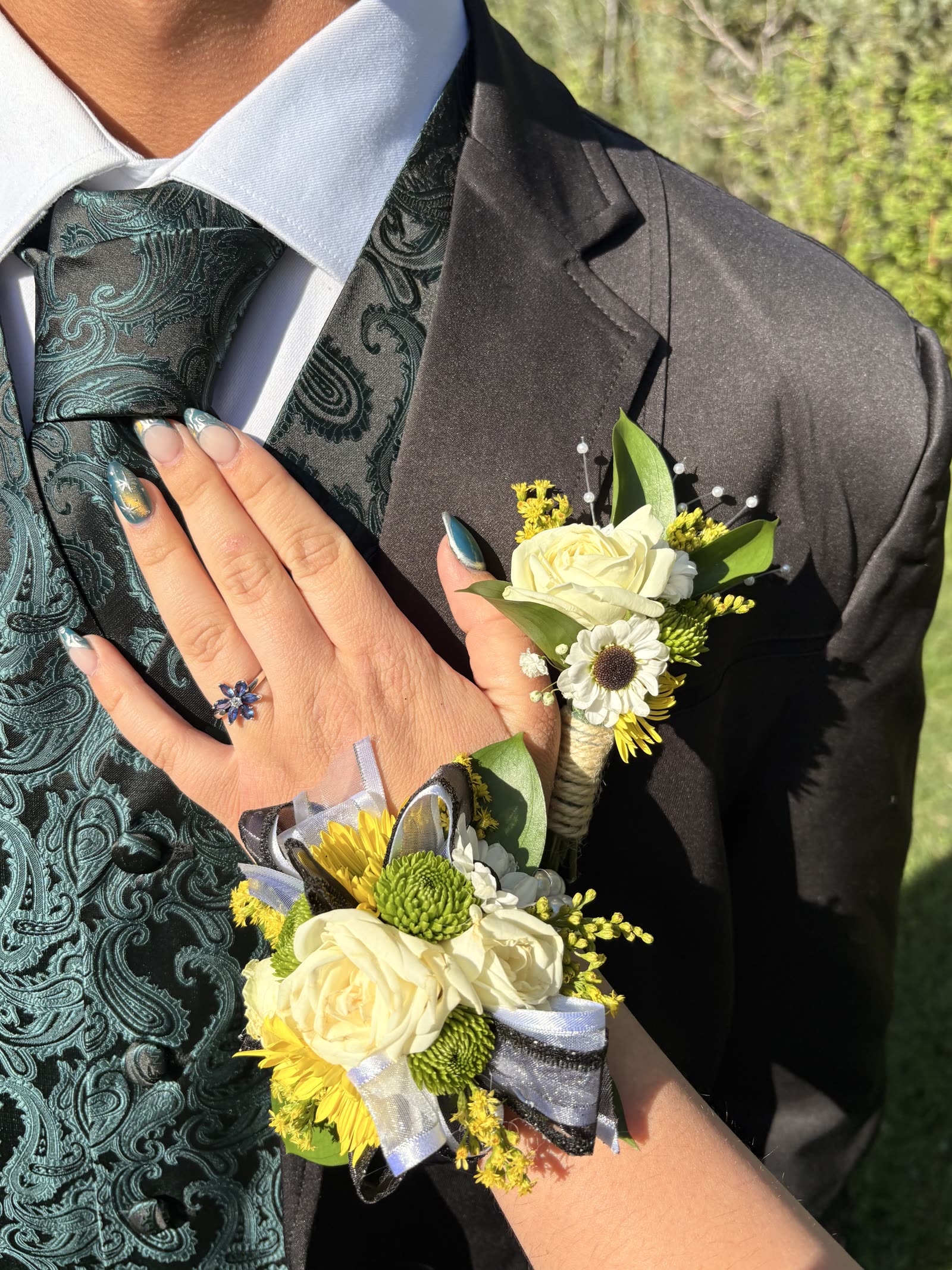Matching prom corsage and boutonniere with white roses and sunflowers